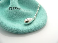 Offered for sale is a gorgeous and very rare Tiffany & Co. Silver Peretti Teardrop Lariat necklace. The piece is crafted from bright and substantial Tiffany silver, with a very pretty teardrop dangling at the end. It is a wonderful necklace that fits a lifestyle on the go -- the necklace can be worn to almost any occasion! It is simple, elegant, and classic all rolled into one necklace. Imagine the piece with your professional office attire ... Now imagine it with jeans or weekend wear ... P Professional Office, Office Attire, Weekend Wear, Lariat Necklace, Charm Gift, Tiffany & Co., Necklace Pendant, Very Rare, The Go