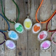 six necklaces with different colors of paint on them