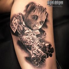 a black and white photo of a baby groote tattoo