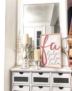 a white dresser topped with lots of drawers and a mirror above it's head