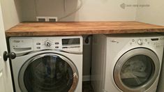 a washer and dryer sitting next to each other in a room with white walls