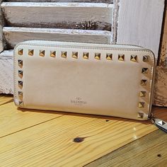 Simply Gorgeous, Absolutely Authentic Valentino Rockstud Leather Wallet. Approx 7.5" X 4". Really Lovely Pre-Owned Condition, See All Pics. Zip Around For Added Security, Zipper Works Perfectly. Interior Is Very Clean, Visible Wear In Interior Fabric Zippered Coin Pocket - That Zipper Works Perfectly As Well. Iconic Gold Pyramid Rockstuds All Firmly Attached. Wear To Fabric Around Exterior Zipper, But All Stitching Is Tight. No Dark Marks/Stains. While Imo, This Beauty Is In Really Guc, Please D Valentino Wallet, Valentino Garavani Bag, Valentino Rockstud, Dark Mark, Interior Fabric, Cream And Gold, Pyramid, Valentino Garavani, Smooth Leather