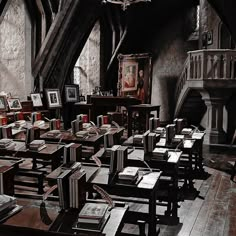 an old school room with desks and books on the tables in front of it