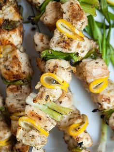 skewered chicken and vegetable kabobs on a white plate