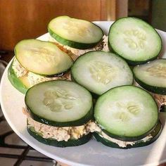 cucumber sandwiches with tuna and cheese on a white platter, ready to be eaten