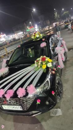 a car decorated with flowers and ribbons