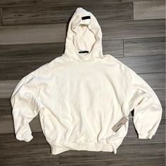 Cozy Cream Colored Hoodie With Logo On Front And Black Branded Tab On Hood. Brand New, Never Worn! Cozy Fit Sweater With Drawstring Hood For Streetwear, White Hooded Sweater For Streetwear, White Sweater With Drawstring Hood For Streetwear, Oversized Comfy Sweatshirt With Adjustable Hood, Cream Relaxed Fit Hoodie For Streetwear, Comfy Long Sleeve Hoodie With Adjustable Hood, Cozy Hoodie With Adjustable Hood, Comfy Streetwear Sweater With Ribbed Cuffs, Cozy Sweatshirt Hoodie