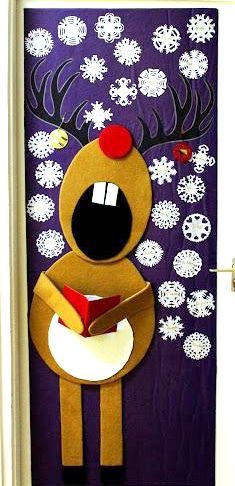 the door is decorated with reindeers and snowflakes on it, while holding a book