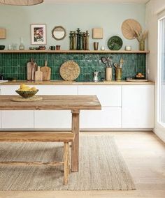 a wooden table sitting in the middle of a kitchen