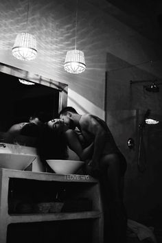 black and white photograph of two people in the bathroom