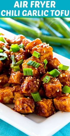 chicken wings with sesame seeds and green onions on a white square plate, text reads air fryer chili garlic tofu