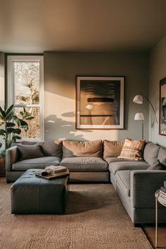 a living room filled with furniture and a large painting hanging on the wall above it