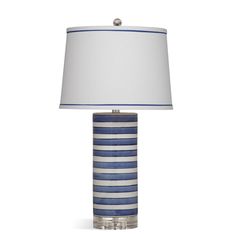 a blue and white striped lamp with a white lampshade on the bottom half