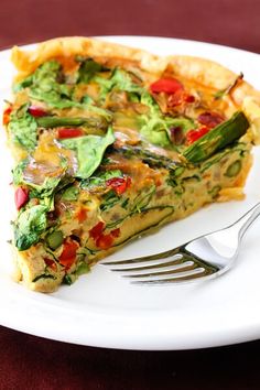 a slice of quiche on a plate with a fork