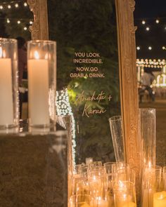 candles are lined up in front of a mirror that says, you look incredible if it's going to grab a drink