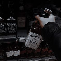 a person holding a bottle of jack daniels