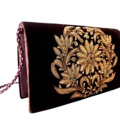 "Lush dark brown velvet clutch bag hand embroidered with antique copper floral wreath and embellished with genuine semi precious gemstones, sewn in. Perfect to wear with autumn tweeds, or when out with friends wearing jeans, an oversized cream colored sweater and cowboy boots! Zardozi means \"gold thread\" or \"writing with gold\". It is an elaborate and intricate art of 3D embroidery using metallic threads and semi precious stones. Zardozi was introduced into northern India in the early 16th ce Traditional Brown Formal Bag, Handmade Brown Evening Clutch, Elegant Handmade Brown Clutch, Luxury Clutch With Gold Embroidery For Festivals, Traditional Brown Shoulder Bag For Formal Occasions, Evening Embroidered Brown Shoulder Bag, Bohemian Embroidered Clutch For Formal Events, Brown Clutch Evening Bag For Wedding, Bohemian Gold Clutch For Formal Occasions