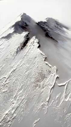 an abstract photograph of snow and ice on a mountain side, with the sky in the background