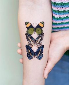 a woman's arm with two butterflies on it