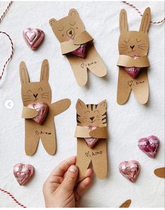 someone is holding up some bunny and cat valentines for the kids to make their own