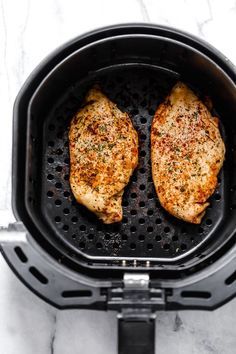 two pieces of chicken in an air fryer