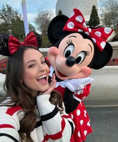 a woman posing for a photo with minnie mouse