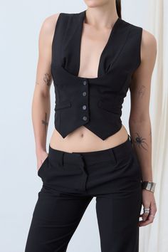 4-button waistcoat with plunging neckline. DETAILS:- Adjustable strap at back- Button closure at front COLOR: Black SIZE & FIT: Model is 32 bust, 25 waist, 38 hip and wearing a size S. FABRIC CONTENT: 52% linen, 48% cotton CARE INSTRUCTIONS: Dry clean only. Air dry. Do not machine dry. Waistcoat Suit, Vest Corset, Phoebe Halliwell, Neckline Details, Fits Inspiration, Bra Pattern, Skirt Patterns Sewing, Pretty Top, Fashion Hacks Clothes