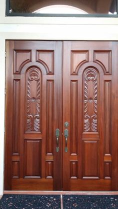 two wooden doors with decorative carvings on them