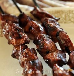 the skewers are covered in sauce on the plate and ready to be eaten