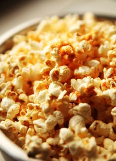 a bowl filled with popcorn sitting on top of a table