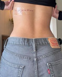 a woman is showing off her stomach with the word love on it's side