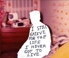 a child's bedroom with a teddy bear on the bed and writing on the wall