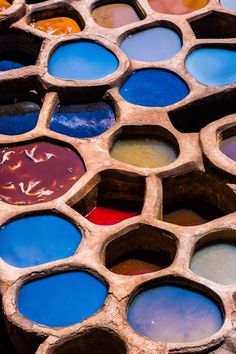 many different colored paints are arranged in the shape of hexagons on display