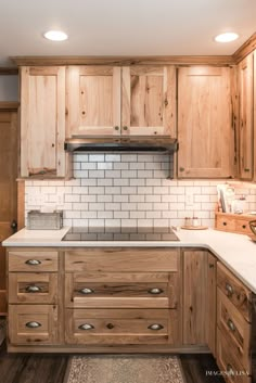 a kitchen with wooden cabinets and white counter tops