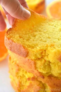 a hand reaching for an orange cake slice