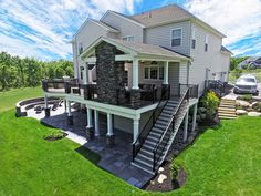 this is an aerial view of a house with stone and metal railings on the front porch