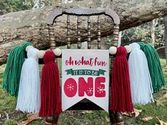 an old chair decorated with tassels and a sign that says on what fun it is to be one