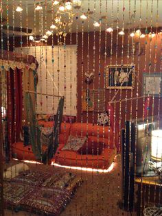 a living room with beads hanging from the ceiling