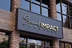 the sign on the side of a building that says social impact project in gold lettering