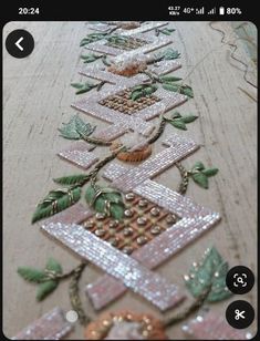 a close up of a table cloth with flowers and leaves on it