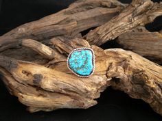 This large Navajo Style Natural blue Kingman (Arizona) Turquoise nugget ring is set in Sterling Silver with a twist rope wrap and heavy double shank band.  This is a large ring I would be proud to wear myself, but am reserving it for You  ..a Friend or your loved one to wear Size-13  and measures 1 1/8" long by 1 1/8" wide.  This ring is a new, never worn, signed piece, and is stamped sterling by my own hand....  Want this ring in another ring size - and similar style stone and look? - Message m Handmade Western Blue Jewelry, Handmade Blue Western Jewelry, Adjustable Blue Turquoise Western Ring, Adjustable Western Style Blue Turquoise Ring, Adjustable Blue Turquoise Ring In Western Style, Kingman Arizona, Navajo Style, Rope Wrapped, Arizona Turquoise