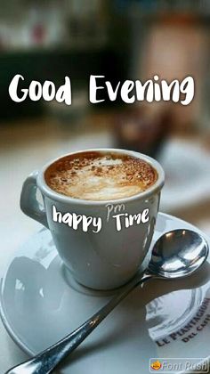 a cup of cappuccino on a saucer and spoon with the words good evening happy time