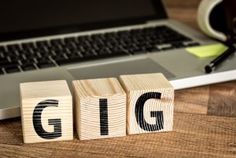 wooden blocks spelling the word ipn next to a laptop