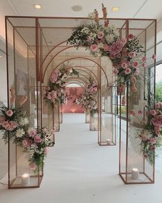 an archway decorated with pink flowers and greenery is featured in the video's title