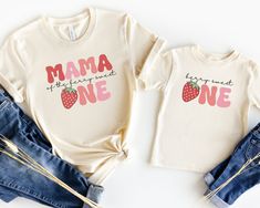 two matching shirts that say mama and one with strawberries on the front, sitting next to each other