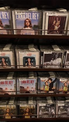 several dvd's are on display in a bookcase at a bookstore or movie store