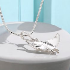 • BEST STINGRAY GIFT FOR OCEAN LOVERS- Beauty and grace captured in a magical moment. Sculpted from Roland's own personal footage captures all the graceful movement of this majestic manta ray. This ocean inspired pendant is a natural conversation piece. This stunning manta design is an original unique stingray gift idea. This beautifully crafted realistic style is perfect for any sea life ocean lover. Look no further, we have the perfect gift for you or your favorite scuba diving friend •PRIDE IN OUR PRODUCTS- This stingray gift for her includes a quality sterling silver flexible and comfortable Italian magic snake chain in your choice of length. Our chain has a solid sterling, high quality, lobster claw style clasp. See our sizing chart for proper fit. Our lead and nickel free jewelry is Magic Snake, Jewelry Ocean, Gift Ide, Graceful Movement, Nickel Free Jewelry, Manta Ray, Ocean Inspired, Ocean Lover, Ocean Inspiration