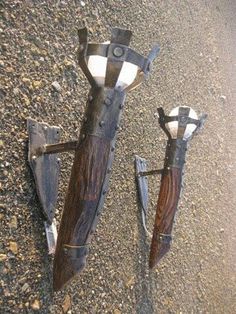 two wooden and metal objects laying on the ground