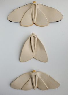 three ceramic moths sitting on top of each other