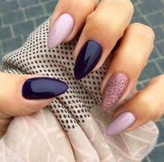 a woman's hands with purple and pink nail polish